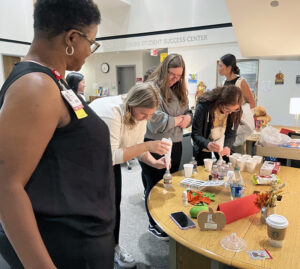 Dr. Kristy Caldwell, Student Services manager, (left) shows students how to make a stress ball.